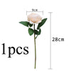 A single cream colored silk rose and peony artificial bouquet with a green stem and leaves.