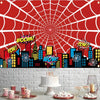 A red spider web background featuring a city skyline silhouette and colorful explosion graphics for a birthday party banner.