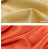 Close-up of smooth satin fabric in two shades, beige and coral orange, showing draped folds.