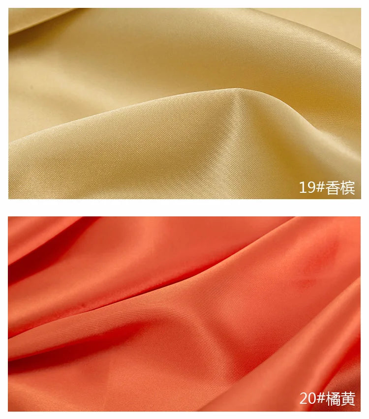 Close-up of smooth satin fabric in two shades, beige and coral orange, showing draped folds.