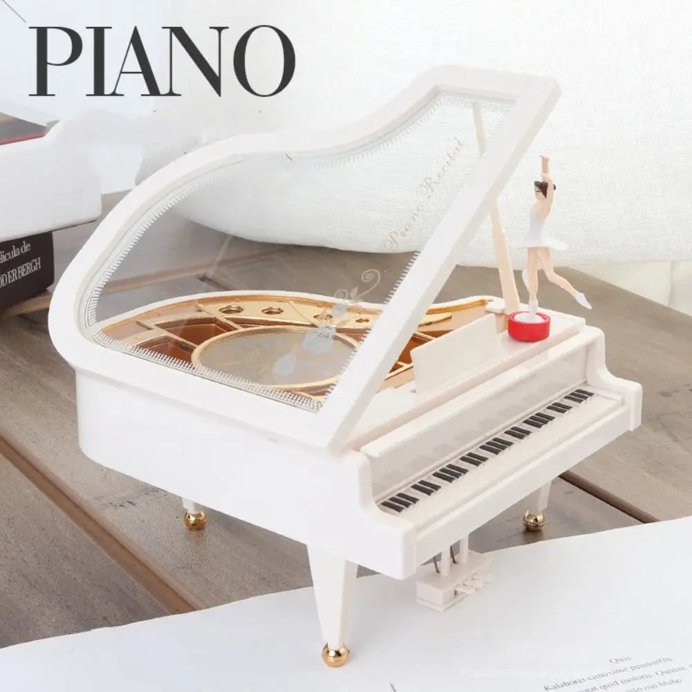 A white hand-crank music box featuring a ballerina figure and a spinning mechanism.