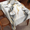 Marble-printed round tablecloth featuring black and gold ink textures on a white background.