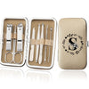 An open leather case displaying an 8-piece stainless steel manicure and pedicure kit with various tools.