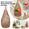 Wall-mounted macrame decorative storage net bag made of natural fiber holding fruits and vegetables