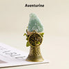 A natural Aventurine crystal mounted in a brass bell with a copper finish.