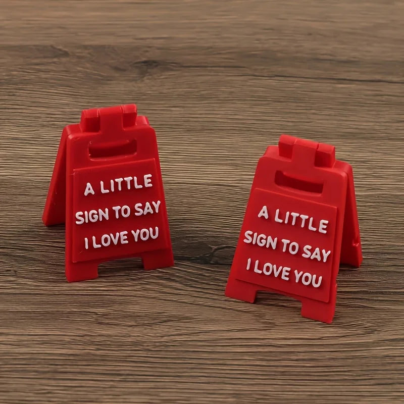 Two red 3D lettering signs shaped like houses, each engraved with the text I love you