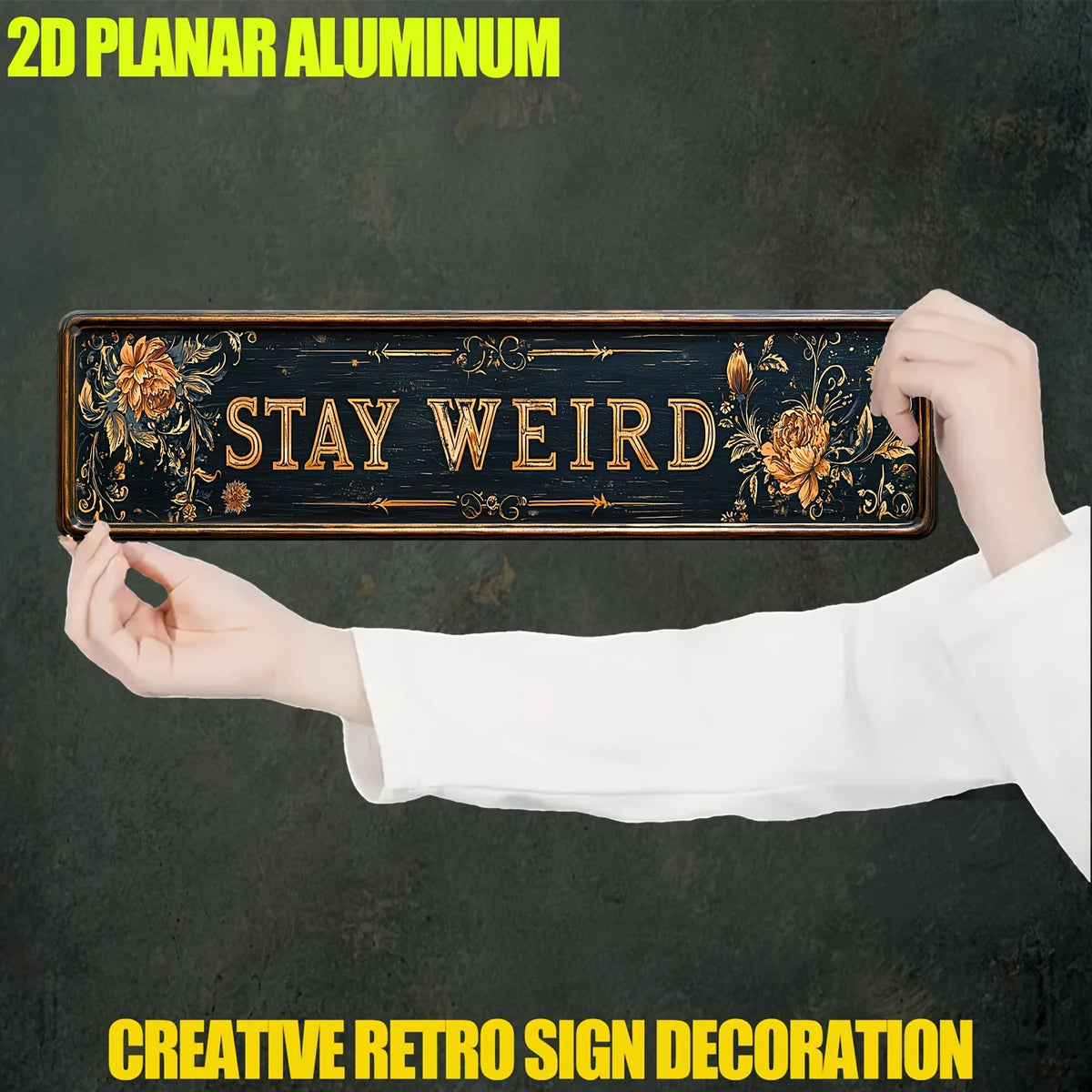 A hand holds a rustic wooden sign with the text STAY WEIRD, used as creative retro sign decoration.