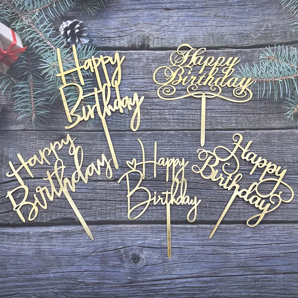 Gold acrylic birthday cake toppers with elegant lettering on a rustic wooden background