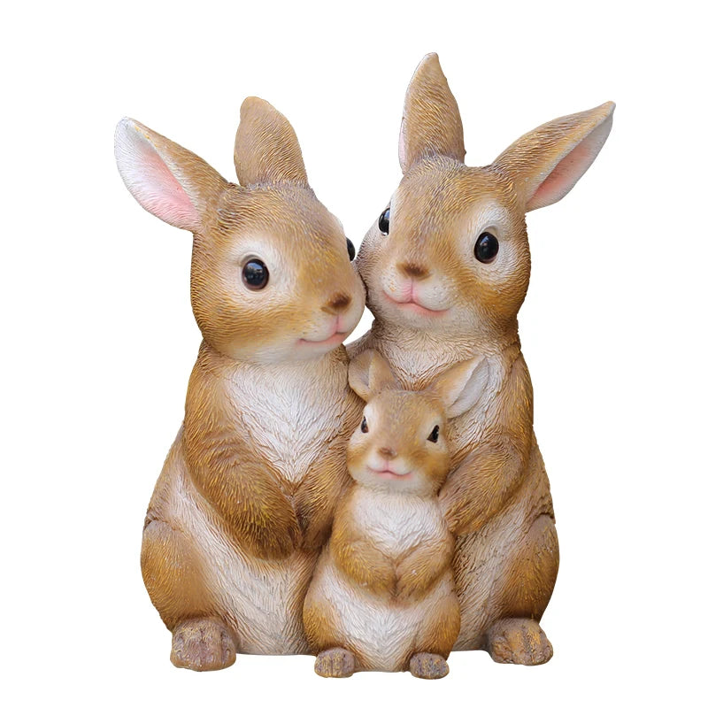 A hand-painted resin garden statue of three adorable baby rabbits sitting together.