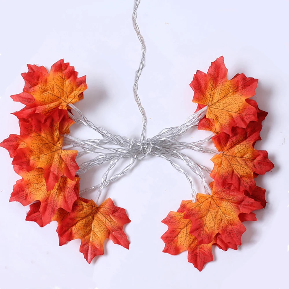 A decorative garland made of autumn-colored faux leaves strung together with thin wire.