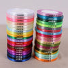 A collection of satin ribbon spools in various colors and widths, arranged in a vertical display.
