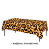 A rectangular table covered with a leopard print tablecloth for party decorations.