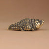 Antique brass crocodile figurine with detailed texture, displayed on a neutral background.