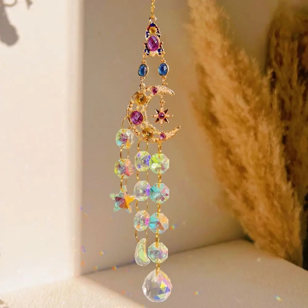 A delicate gold crystal suncatcher wind chime ornament featuring purple and blue stones hanging from a chain.