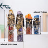 Three glass bottles filled with natural crystals and raw stones, showing various colors like amethyst, orange, and blue.