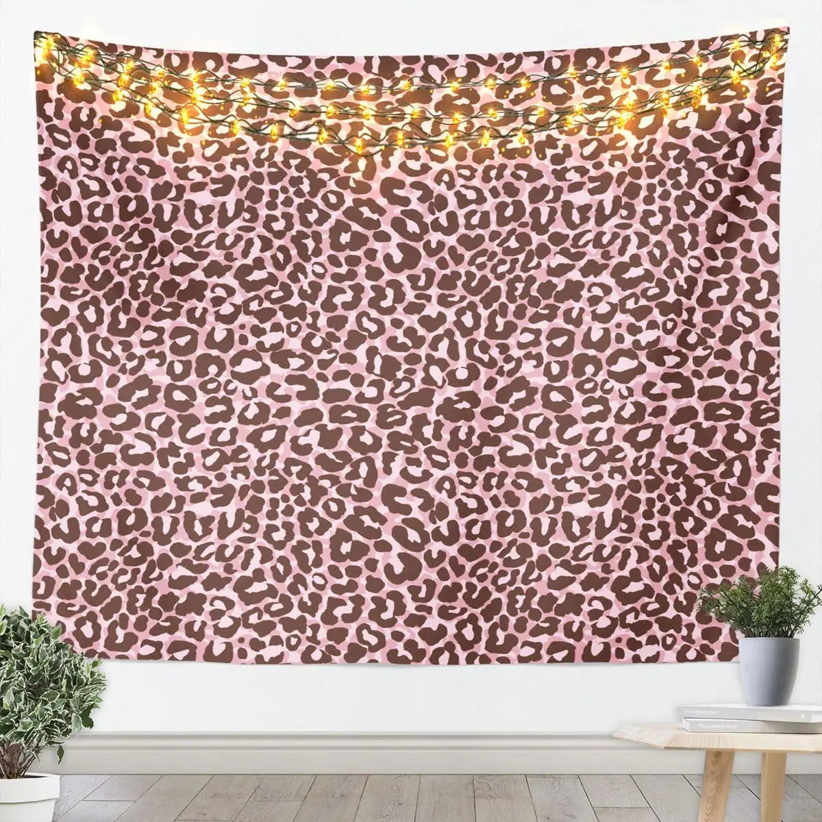 A leopard print tapestry wall hanging featuring brown and pink wild animal pattern decor.