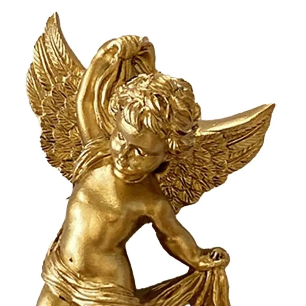 A golden cherub angel sculpture with feathered wings.