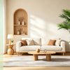 A faux artificial areca palm tree in a white pot displayed in a modern living room setting.
