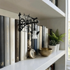 A vintage bookshelf lantern lamp displayed on a white shelf among books and decorative items.