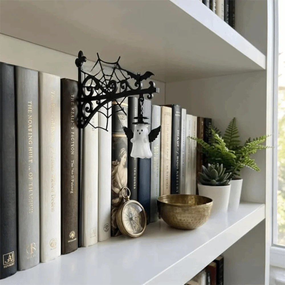 A vintage bookshelf lantern lamp displayed on a white shelf among books and decorative items.