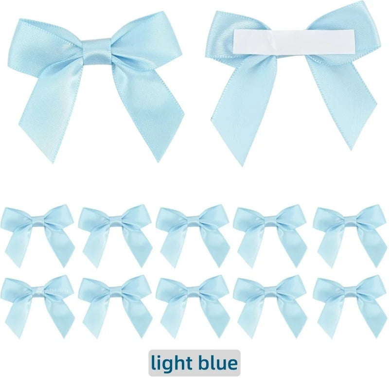 A set of light blue satin ribbon bows with self-adhesive backing for crafting and gift wrapping.