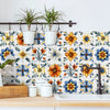 A set of self-adhesive waterproof wall decals featuring floral patterns in yellow, orange, blue, and green on a white tile ba