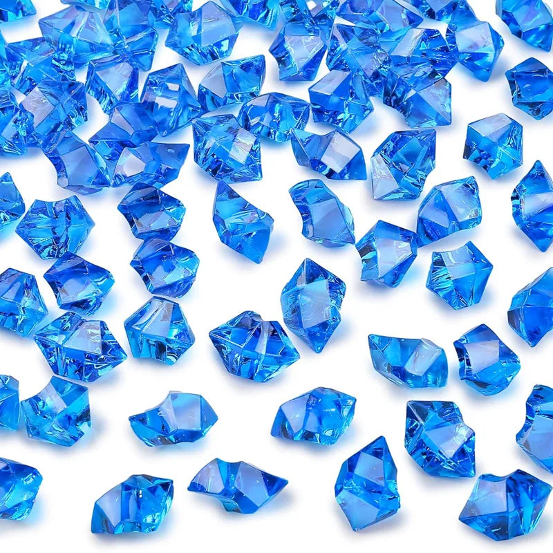 Blue decorative crushed diamond acrylic pebbles scattered on a white background
