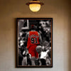 A framed black and white photograph of Dennis Rodman in a red basketball uniform.
