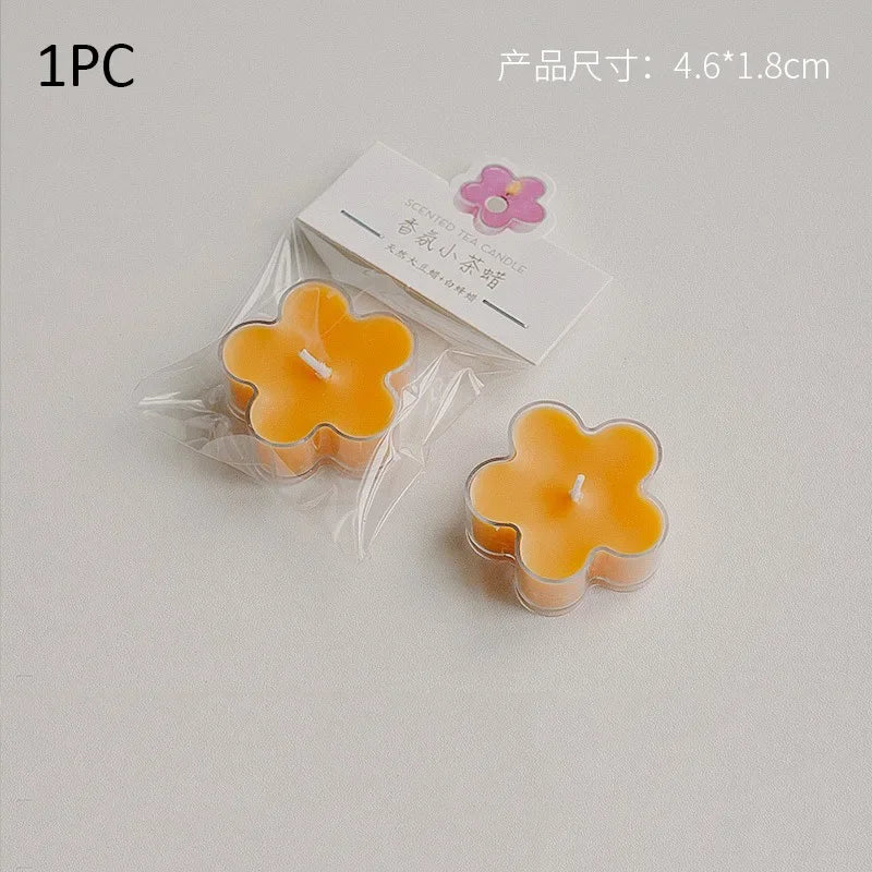 One piece of a yellow flower tea light candle in clear packaging with a pink floral sticker.