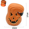 An orange carved pumpkin decoration with a smiling face and black accents, shown from the side.