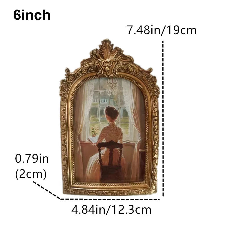 A vintage resin rotating photo frame with an ornate gold frame displaying a portrait.