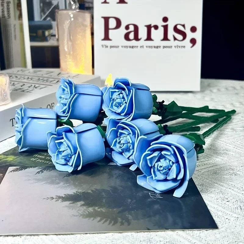 A bouquet of blue roses made from DIY flower building blocks displayed on a dark surface.