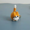 Handcrafted crochet cat keychain pendant in orange and white yarn