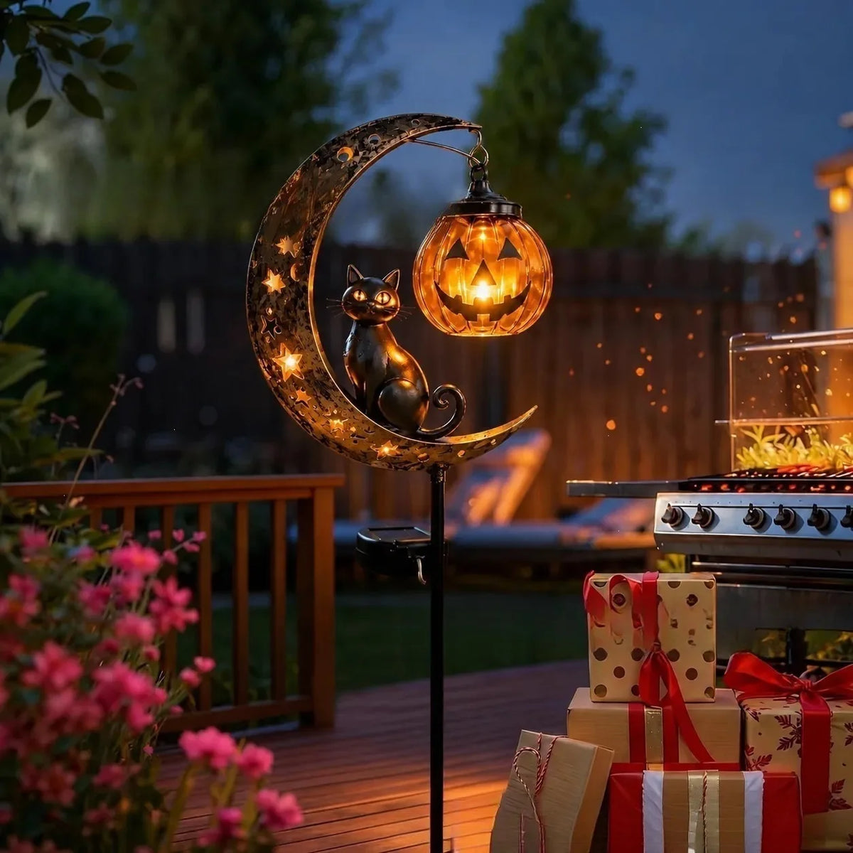 A solar-powered pumpkin moon garden stake light featuring a carved cat silhouette on a crescent moon.