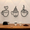 A trio of black metal wall art featuring stylized coffee cups or mugs mounted on a white wall.