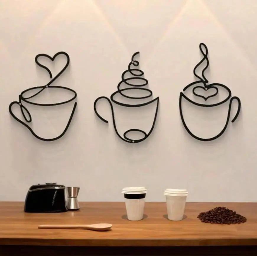 A trio of black metal wall art featuring stylized coffee cups or mugs mounted on a white wall.
