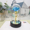 Rose de verre éternelle avec une fleur bleue et lumière LED sur une base noire.