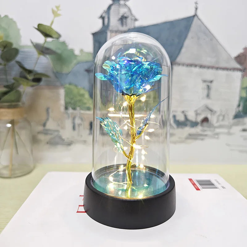 Rose de verre éternelle avec une fleur bleue et lumière LED sur une base noire.