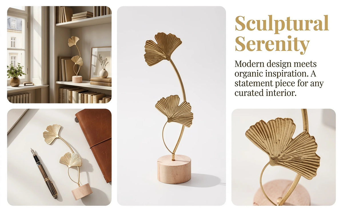 A golden ginkgo leaf ornament on a slender stem displayed on a round wooden base.