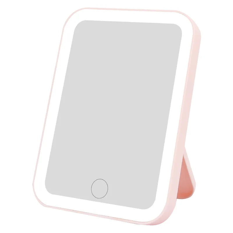 A rectangular touch screen LED vanity mirror with a pink frame and illuminated display.