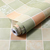 Roll of waterproof oil-proof kitchen wall sticker in pale green and beige tones on a tiled surface.