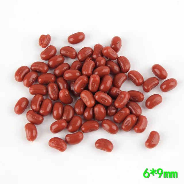 A pile of realistic, reddish-brown resin fake corn miniatures measuring 6x9mm.