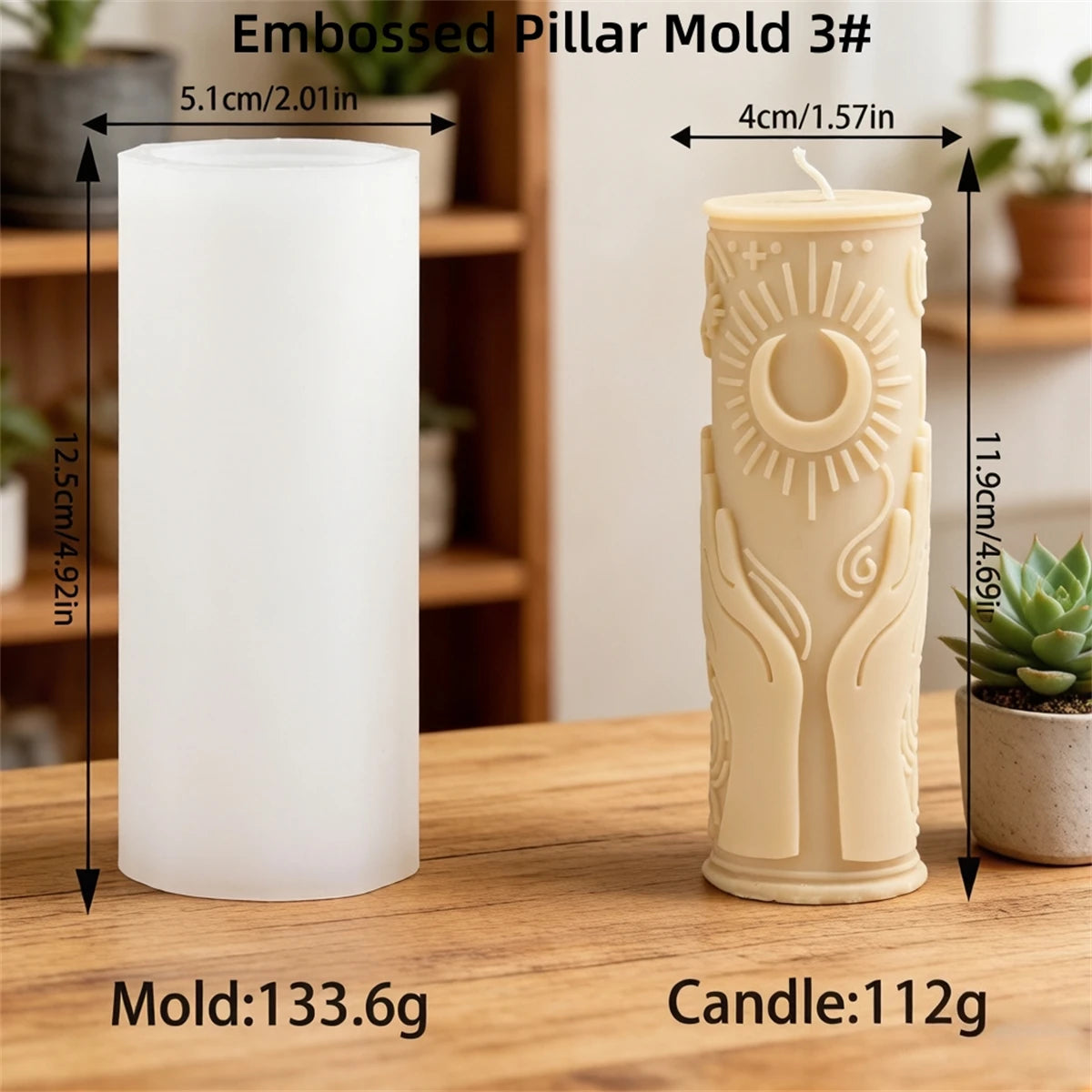 A white embossed pillar mold and a beige candle are displayed on a wooden surface.