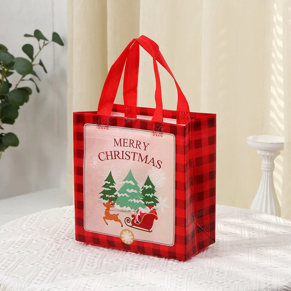 A red plaid gift tote bag with a pink Christmas print and red handles resting on a white surface.