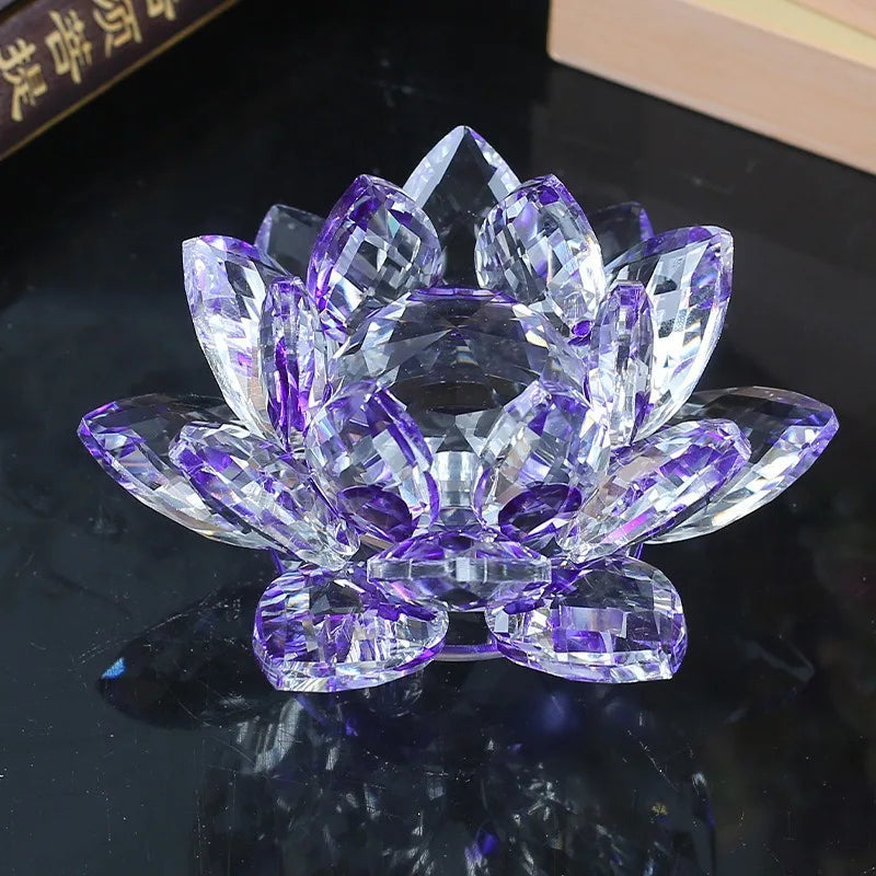 A clear crystal lotus flower ornament with purple and violet facets, displayed on a dark surface.