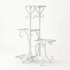 A white metal corner plant stand with four tiers for indoor and outdoor use.