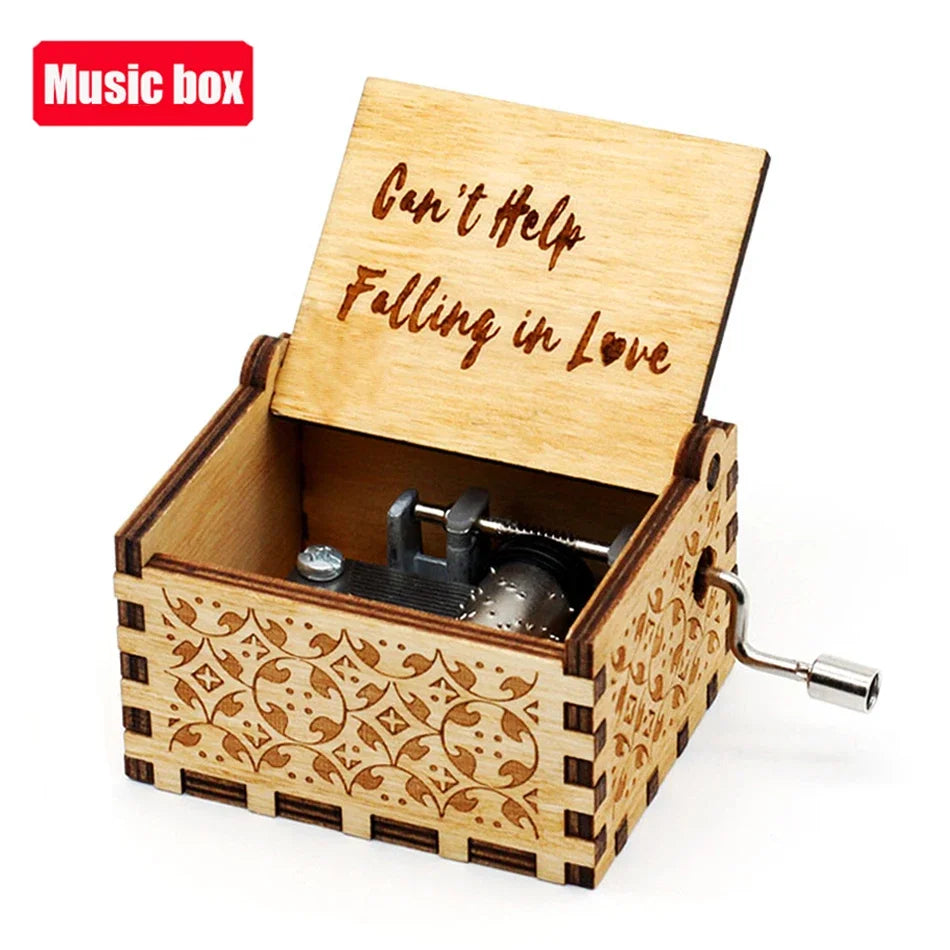 A carved wooden music box with an open lid displaying the text Can't Help Falling in Love