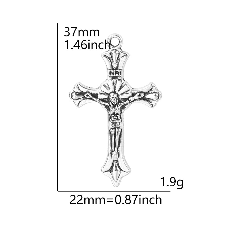A silver crucifix cross charm with a detailed depiction of the crucifixion.