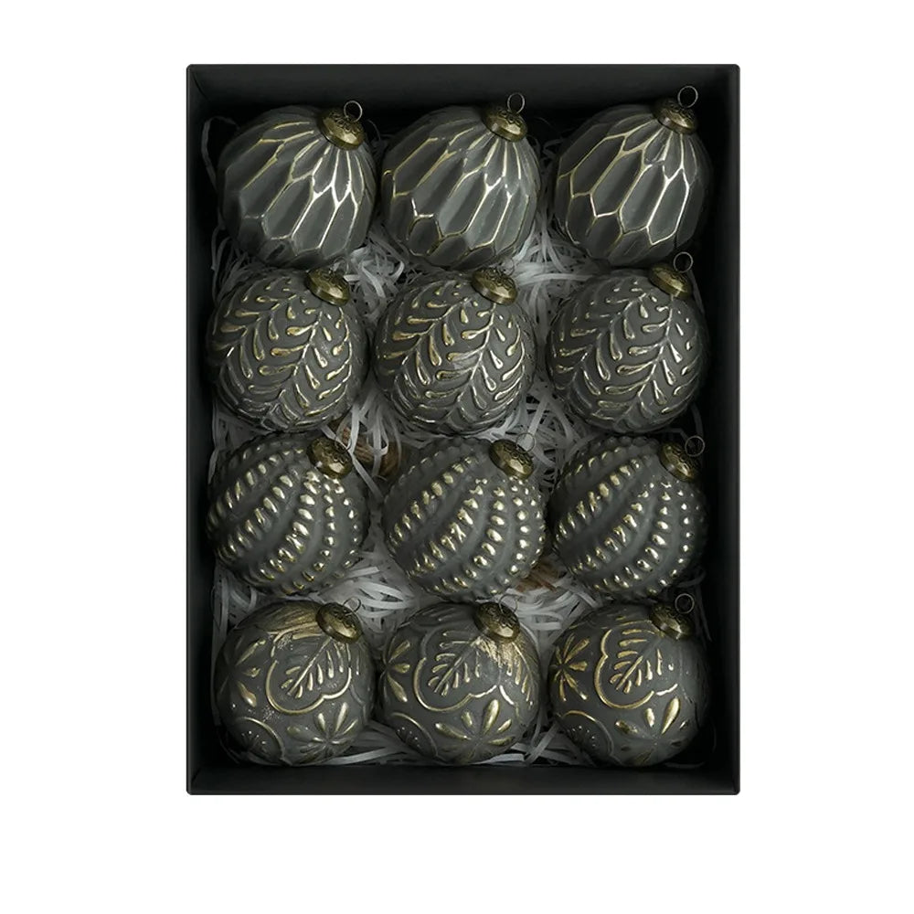 A set of twelve antique silver-green shatterproof Christmas tree ball ornaments displayed in a black box.