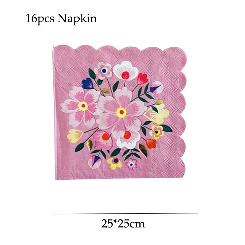 A pink floral napkin with various colored flowers and leaves.